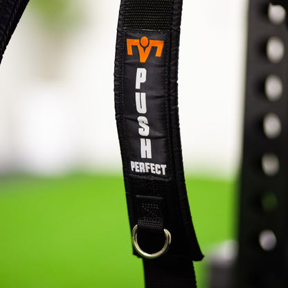 Close-up of the PUSH Perfect shoulder strap with the logo and a metal D-ring